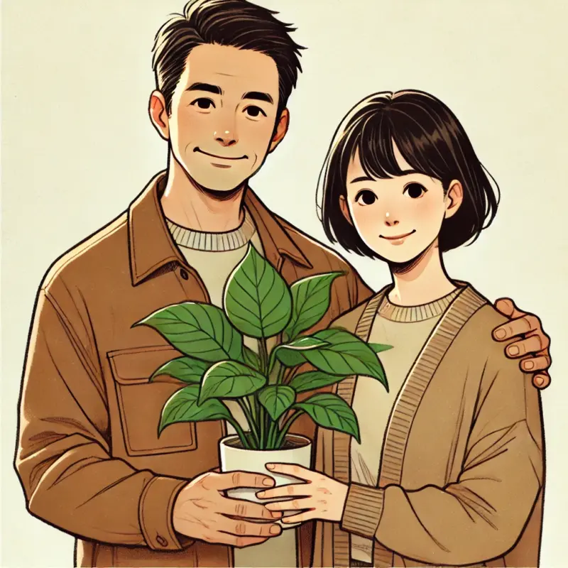 観葉植物を２人で抱えた４０代の幸せそうな夫婦